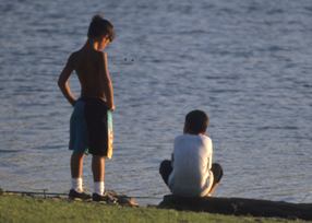 Boys fishing on the lakeshore