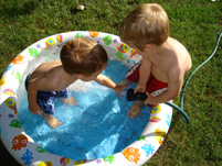 two boys in inflatable plastic pool