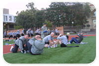 Lt. Col. Martha Kiene, deputy commander for the USACE Los Angeles District, monitors participants in the sit-up portion of the Army Physical Fitness Test Jan. 29 with members of the USC Army Reserve Officers Training Corps in the background. Two USACE civilians joined four military members for the semiannual event at the USC track.