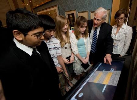 Students and Dr. Billington interact with a Library of Congress Experience kiosk