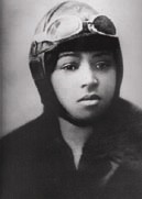 Photo of Bessie Coleman wearing an aviator's helmet and goggles.