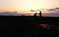 Sunrise greets couple watching Kohola arm of Mother's Day flow, Kilauea volcano, Hawai'i