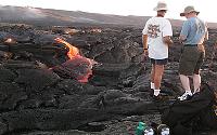 Visitors in shorts watch breakout in Kohola arm of Mother's Day flow, Kilauea volcano, Hawai'i