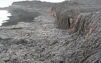 Lava on beach below Highcastle sea cliff, Kilauea volcano, Hawai'i