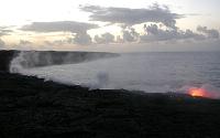 Steam rises from entries at front of beach-covering flow, Highcastle area, Kilauea volcano, Hawai'i