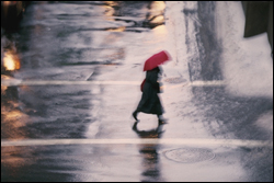 Person with umbrella walking in the rain