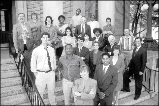 Photo of a group of people standing on the steps of a building.