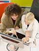 Two women working on a computer