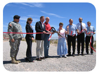 U.S. Reps. Porter and Berkley (third and fifth from left) join state, local and other federal representatives in cutting the ribbon that marks completion of the Corps' Tropicana-Flamingo segment of the Clark County Flood Control Project. The project will minimize the potential for flood damage in nearby Las Vegas.