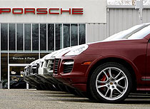 Porsche cars are seen lined up at a dealer in Peabody, Mass. Monday, Jan. 5, 2009