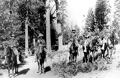 Five African-American soliders on their horses with their shotguns hanging from their backs at National Park