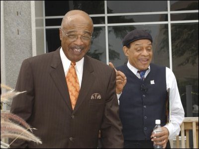 Secretary Paige and jazz vocalist Al Jarreau share a moment at an August 25, 2004, event celebrating the distribution of books to several non-profit education organizations.  The event, held at the U.S. Department of Education, was hosted by the Verizon Foundation, First Book, and DisneyHand.