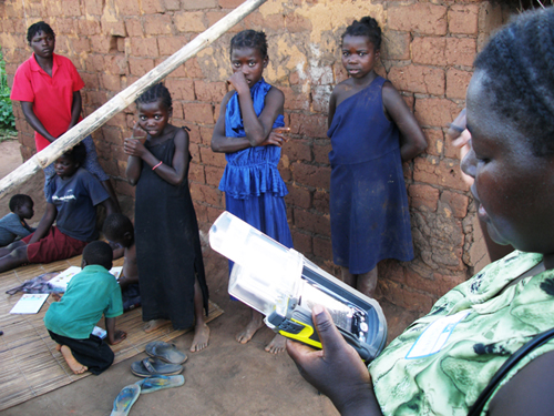 Ms. Virginia Taona of the Mozambican Red Cross uses a PDA equipped with a GPS in a survey of insecticide-treated bednets in rural Mozambique, February 2006.