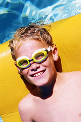 A boy on a raft in a pool