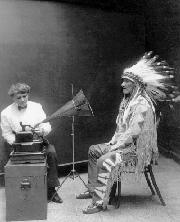 Mountain Chief of the Blackfoot Tribe listens to a cylinder recording of a Blackfoot song made by Frances Densmore