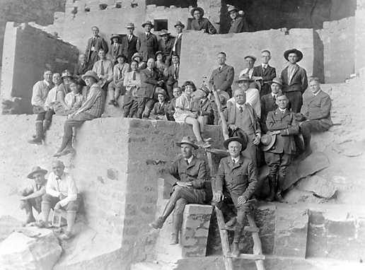 This is an image of men sitting on earth abode at National Park