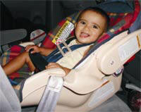 picture of baby properly restrained in a car seat