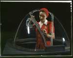 Girl putting

finishing touches on the bombadier nose section of a B-17F navy

bomber