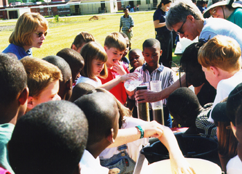 Hydrologist and students study the flow of water through sand