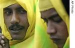 Two Acehnese men attend a protest against the placing of a police post in their village in front of the Aceh Monitoring Mission headquarters in Banda Aceh, Indonesia, Tuesday, July 25, 2006