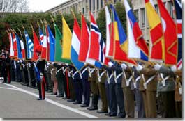 A color guard stand with the NATO member flags at a flag raising ceremony at NATO Headquarters in Brussels.