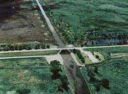 An overhead photo of a dam. The river trails off into the background.