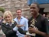 A picture of Diane Sawyer, Chris Cuomo and a young man holding a trophy.