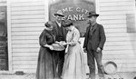 Group of Two Men and Two Women Examining Gold outside of Bank