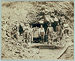 Group of men at mine entrance