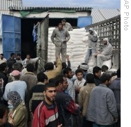 Palestinians gather to receive flour at a United Nations food distribution center in Gaza City, 08 Jan 2009