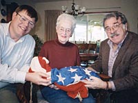 M. Gertrude Hawkey presenting flag