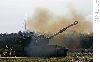 An Israeli army mobile artillery piece fires towards targets in the southern Gaza Strip, at a position on the Israel side of the border with Gaza Sunday, 04 Jan. 2009
