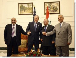 President George W. Bush poses for photos with Iraq's President Jalal Talabani, left, and Iraq Vice Presidents Adil Abdul-Mahdi and Tariq al-Hashimi, right, during their meeting Sunday, Dec. 14. 2008, at the Salam Palace in Baghdad.  White House photo by Eric Draper