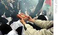 A man in Tehran blesses Iranians wearing white shrouds to indicate their willingness to die to defend Gaza, 01 Jan 2009