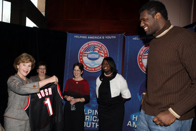 Mrs. Laura Bush holds an National Basketball Association basketball jersey presented to her by NBA player Mr. Greg Oden of the Portland Trail Blazers, during the regional conference on Helping America's Youth at the Portland Center for the Performing Arts in Portland, Ore. Also attending the presentation are, from left, Ms. Robyn Williams, executive director, Portland Center for the Performing Arts; Mrs. Mary Oberst, first lady of Oregon; and student, Ms. Shantel Monk. White House photo by Shealah Craighead