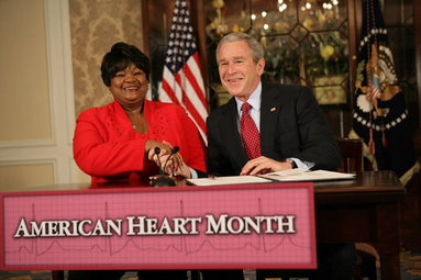 President George W. Bush shakes the hand of Joyce Cullen, a heart disease survivor, after signing the Presidential Proclamation in Honor of American Heart Month Friday, Feb. 1, 2008, in Kansas City, Mo. In signing the proclamation, the President thanked Mrs. Cullen for her work and said, "...She's very much a part of the Heart Truth Campaign here in Kansas City. And she's helping people understand two things -- one, be able to recognize the symptoms, and secondly, be able to prevent the symptoms from happening in the first place... So I want to thank you for being a strong leader in the campaign for awareness." White House photo by Eric Draper