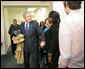 With Mrs. Laura Bush by his side, President George W. Bush speaks to reporters Monday, Dec. 22, 2008, during a visit to the Pathways to Housing DC, a distribution site for the One Warm Coat Holiday Service Project, in Washington, D.C. Modeled after the first Pathways to Housing program in New York City founded in 1992, Pathways to Housing DC works with individuals who have been turned away from other programs. White House photo by Shealah Craighead