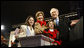 President George W. Bush and Mrs. Laura Bush are joined by tree lighters Kayleigh Kepler, 11, left, and Lindsey Van Horn, 9, during the 2008 Lighting of the National Christmas Tree Thursday, Dec. 4, 2008, on the Ellipse in Washington, D.C. White House photo by Eric Draper