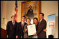 Mrs. Laura Bush presents the Fifth Annual Preserve America History Teacher of the Year award to David Mitchell, right, Friday, Oct. 24, 2008, at the Union League Club in New York City. She is joined by Dr. James Basker, President, Gilder Lehrman Institute of American History, left, and David Mitchell's students from Masconomet Regional High School in Boxford, Mass., David Burbank, 17, and Molly Byman, 18. The award notes the importance of teaching history and highlights the Preserve America initiative. White House photo by Chris Greenberg