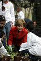 Mrs. Laura Bush helps children plant flowers at the First Bloom Event, Monday, April 21, 2008, during her visit to celebrate National Park week at the Castle Clinton National Monument in New York City. White House photo by Shealah Craighead