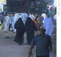 Saudi women walk together in a marketplace