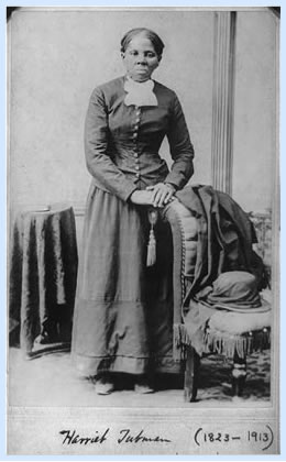 [Harriet Tubman, full-length portrait, standing with hands on back of a chair]
