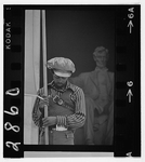 Photograph showing a man on the steps of the Lincoln Memorial holding a banner for the Revolutionary People's Constitutional Convention; statue of Lincoln in the background.