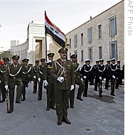 The Guards of Honour of the Iraqi National Forces parade as they fly the Iraqi flag outside the former palace of ousted dictator Saddam Hussein inside the Green Zone in Baghdad, 01 Jan 2009