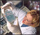 Photo of scientist doing confirmatory test for E. coli
