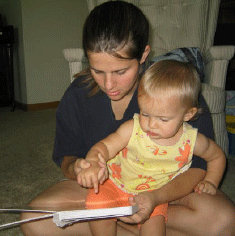 photo of a young woman teaching a child