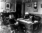 Black and white photo of then Vice President Theodore Roosevelt sitting at his desk in the Vice President's Office.