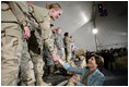 Mrs. Laura Bush greets U.S. and Coalition troops Wednesday, March 1, 2006, during a stopover at Bagram Air Base in Afghanistan, prior to the President and Mrs. Bush visiting India and Pakistan.