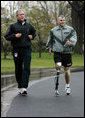 President George W. Bush runs with U.S. Army Staff Sergeant Michael McNaughton, of Denham Springs, La., on the South Lawn of the White House Wednesday, April 14, 2004. The two met January 17, 2003, at Walter Reed Army Medical Center, where SSgt. McNaughton was recovering from wounds sustained in Iraq. The President then wished SSgt. McNaughton a speedy recovery so that they might run together in the future. White House photo by Eric Draper