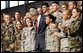 President George W. Bush stands with military personnel on stage Monday, Aug. 4, 2008, after delivering remarks at Eielson Air Force Base during a stop in Alaska en route to South Korea. White House photo by Eric Draper